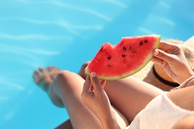 Photo of Woman with slice of juicy watermelon near swimming pool outdoors, closeup