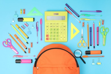 Photo of Backpack and different school supplies on light blue background, flat lay