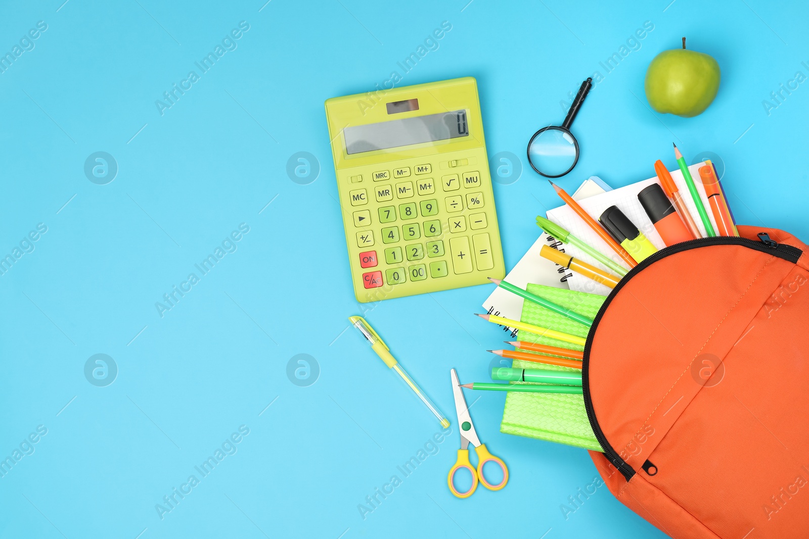 Photo of Backpack and different school supplies on light blue background, flat lay. Space for text