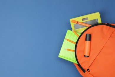 Photo of Backpack and different school supplies on blue background, top view. Space for text