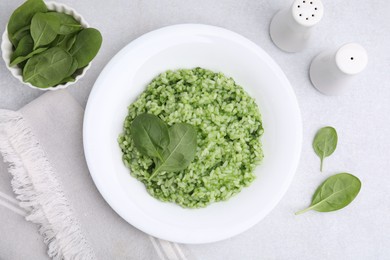 Photo of Delicious spinach risotto on light grey table