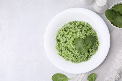 Photo of Delicious spinach risotto on light grey table