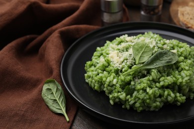 Photo of Delicious spinach risotto with parmesan cheese served on table, closeup