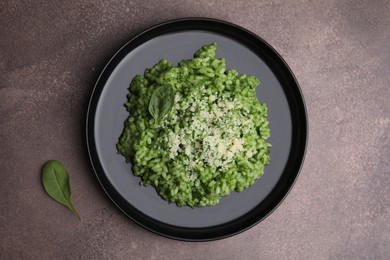 Photo of Delicious spinach risotto with parmesan cheese on grey table, top view