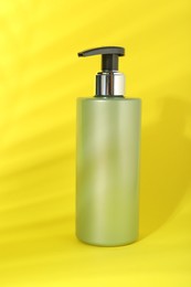 One shampoo in bottle on yellow background