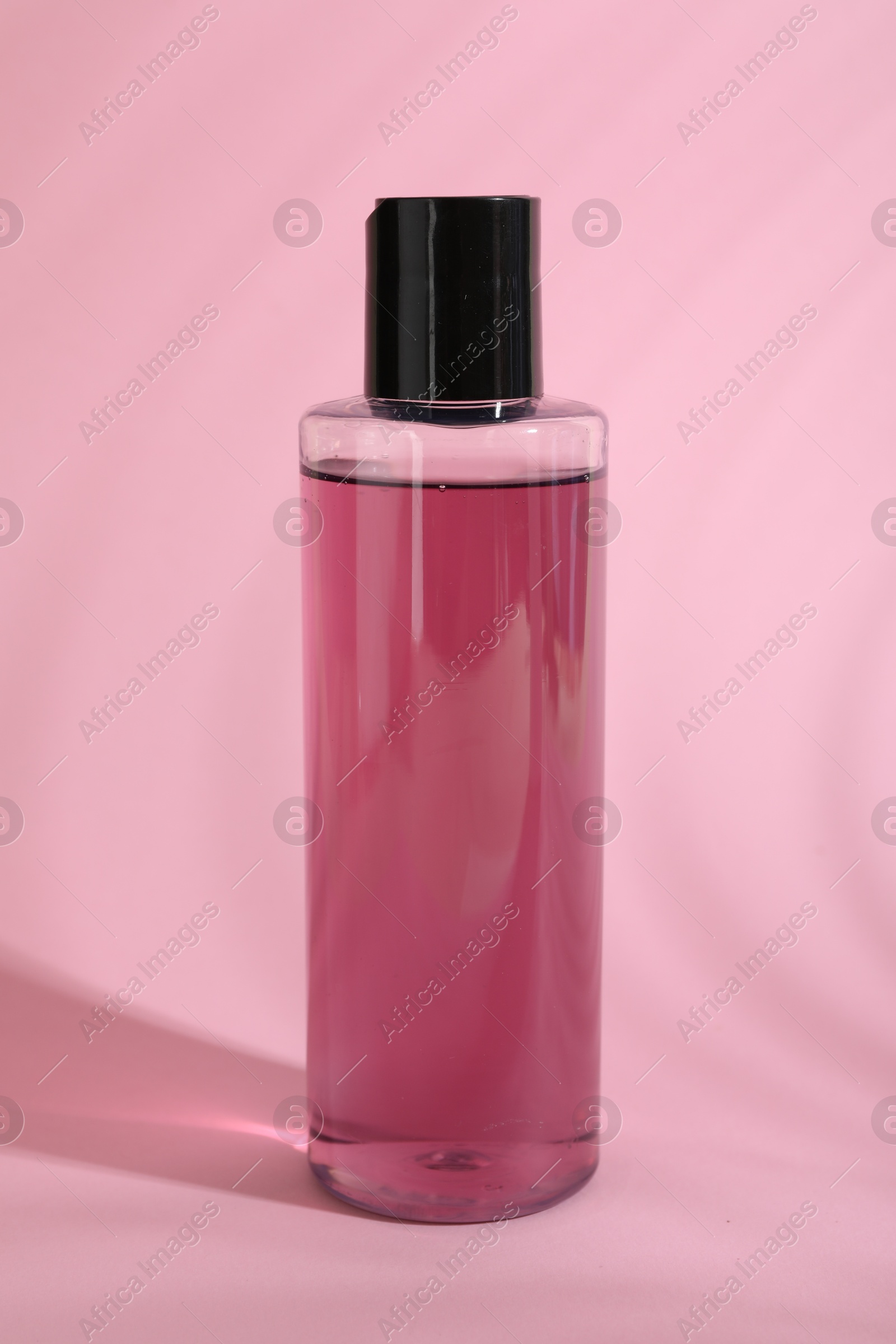 Photo of One shampoo in bottle on pink background