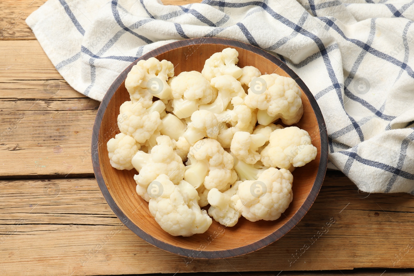 Photo of Tasty cauliflower on wooden table, top view