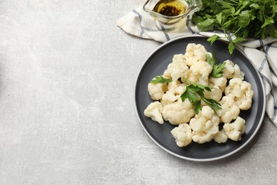 Photo of Tasty cauliflower with parsley on grey table, flat lay. Space for text