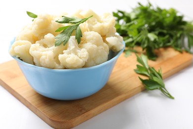 Photo of Tasty cauliflower with parsley on white table, closeup