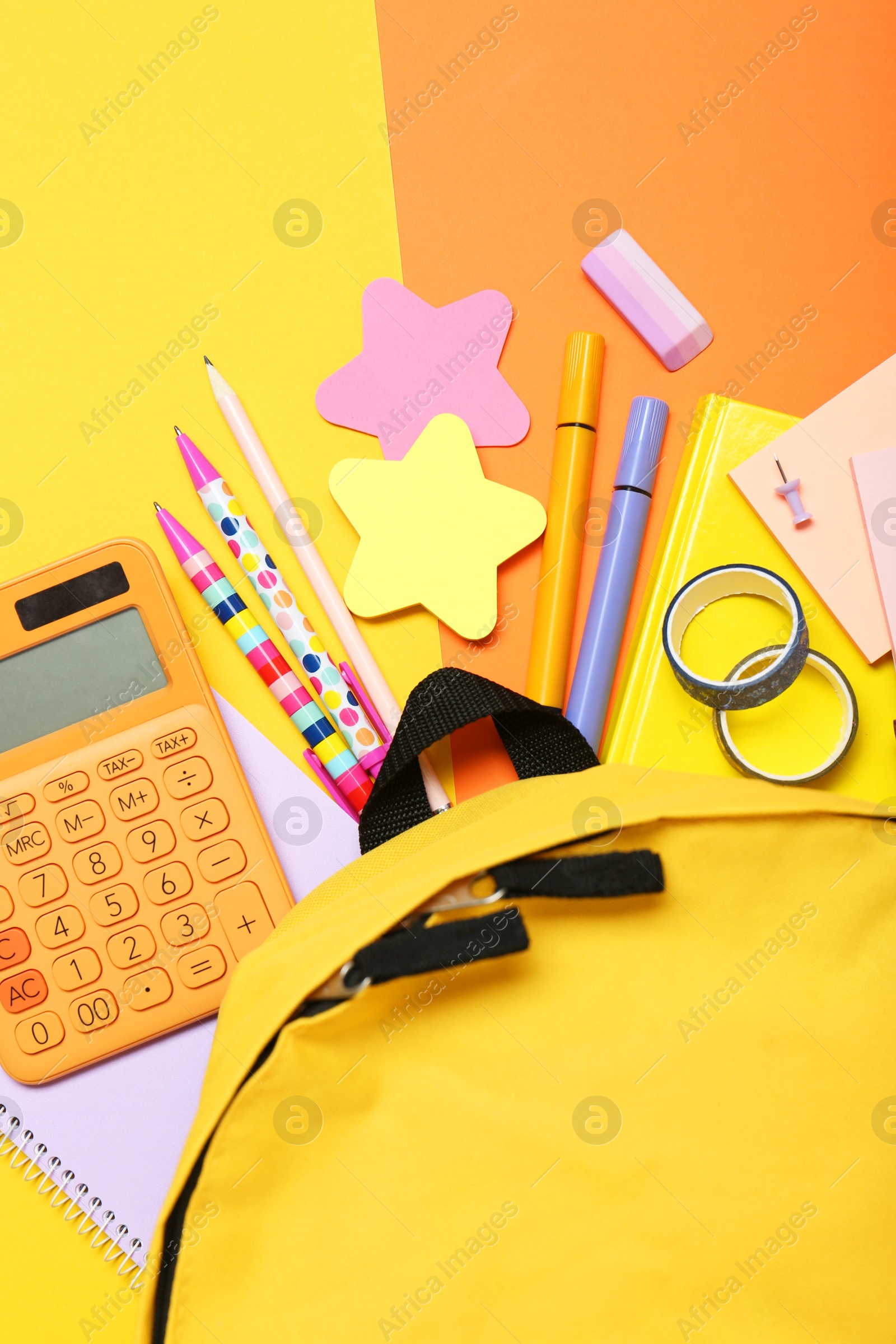 Photo of Backpack and different school stationery on color background, flat lay