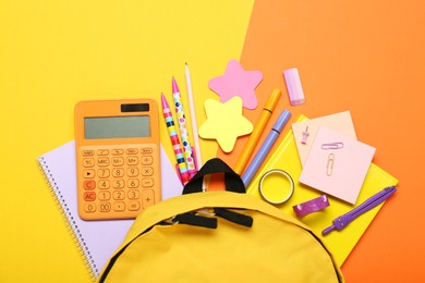 Photo of Backpack and different school stationery on color background, flat lay