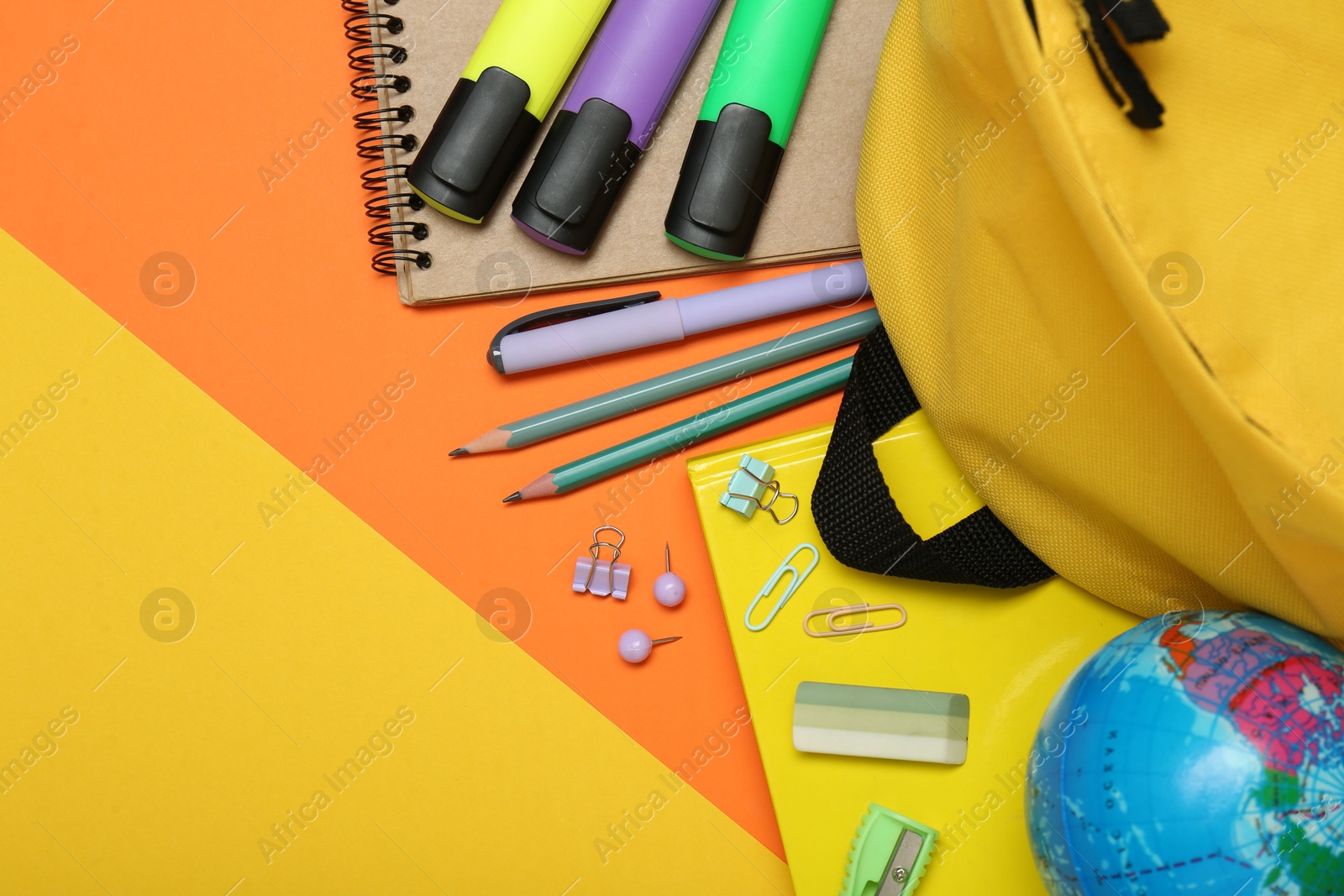 Photo of School backpack and stationery on color background, flat lay. Space for text