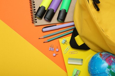 Photo of School backpack and stationery on color background, flat lay. Space for text