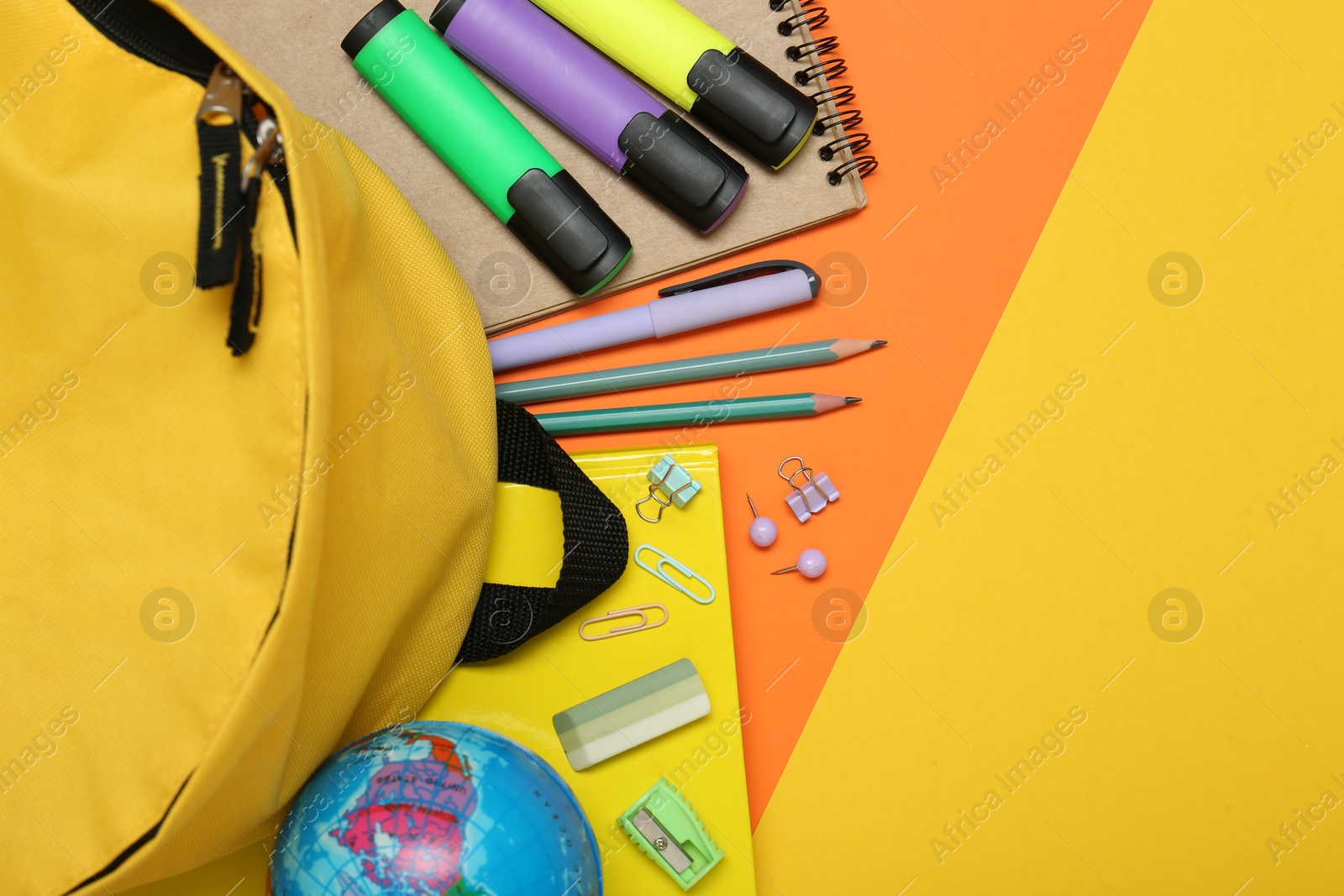 Photo of School backpack and stationery on color background, flat lay. Space for text