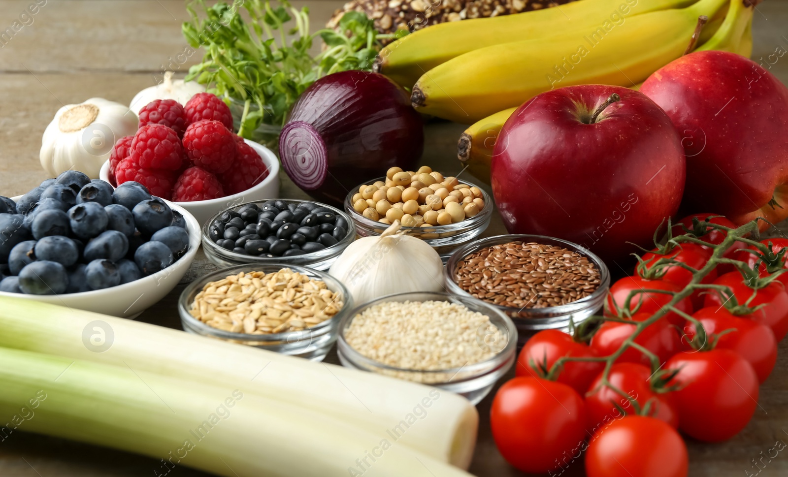 Photo of Different fresh products on wooden table, closeup. Source of prebiotics