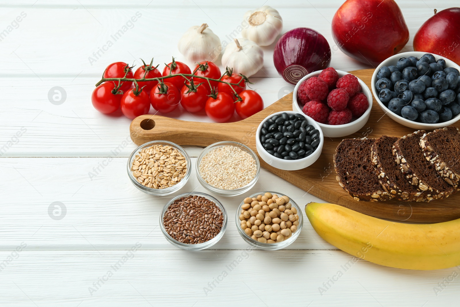 Photo of Different fresh products on white wooden table. Source of prebiotics