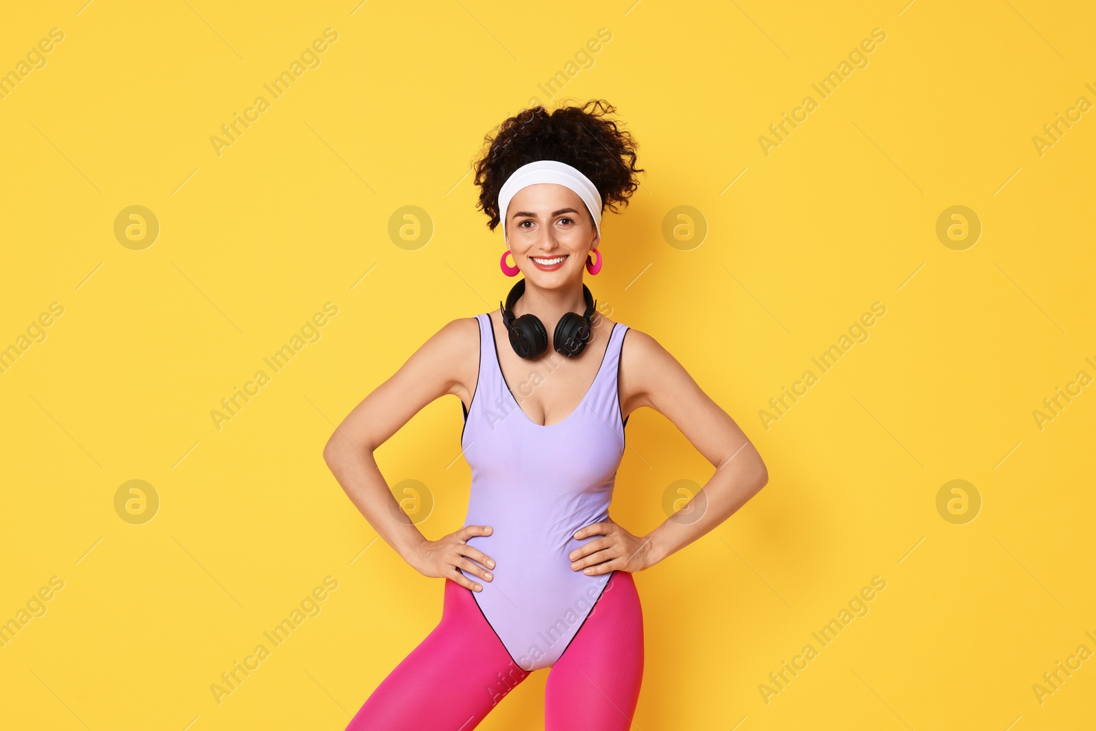 Photo of Happy woman with headphones on orange background