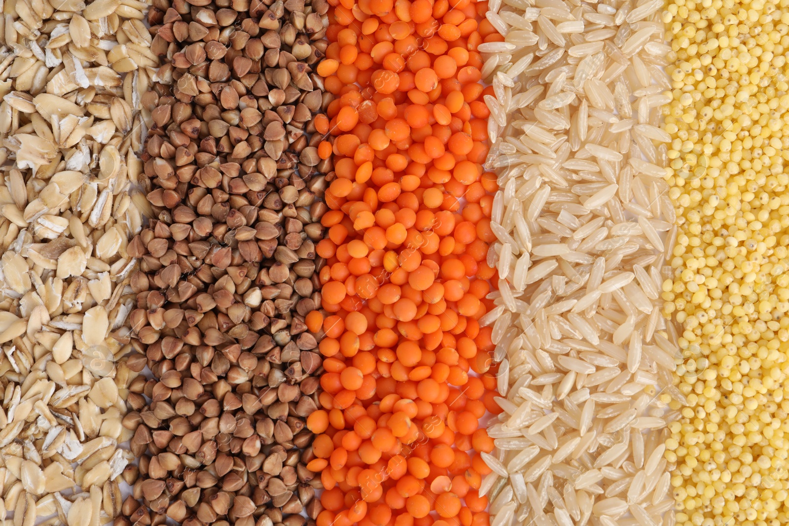 Photo of Different grains and cereals as background, top view