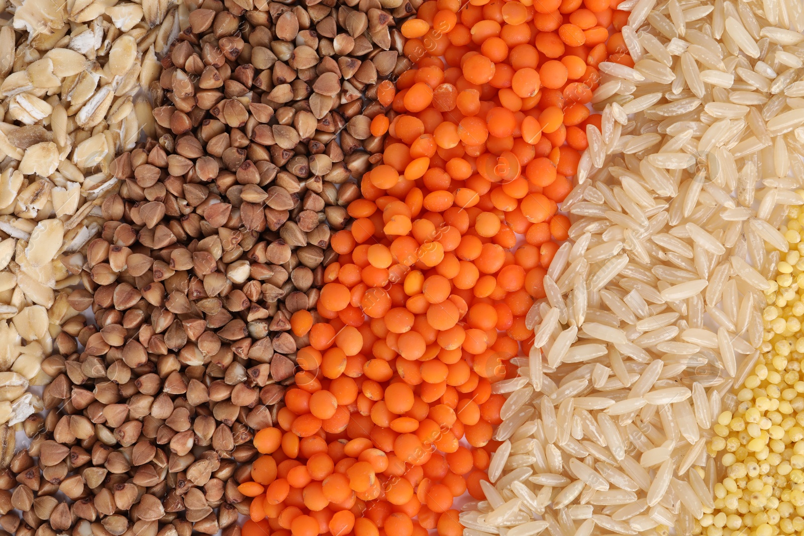 Photo of Different grains and cereals as background, top view