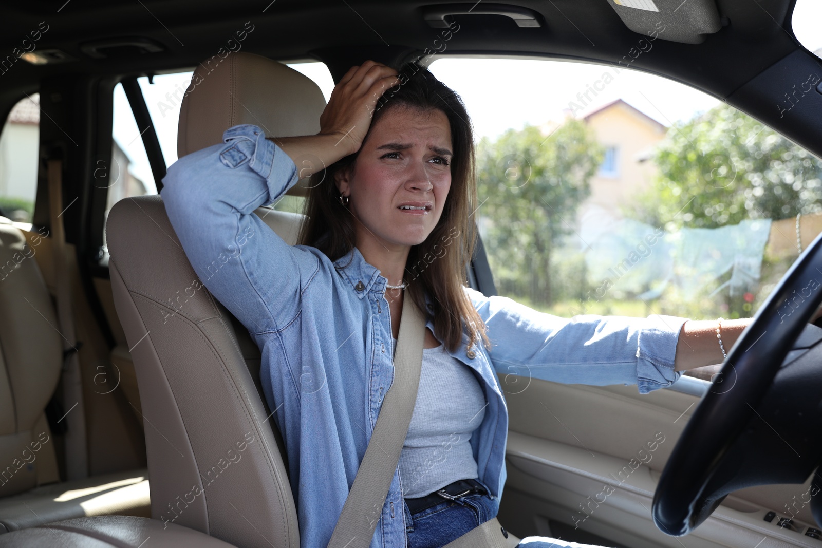 Photo of Sad woman holding steering wheel while driving car