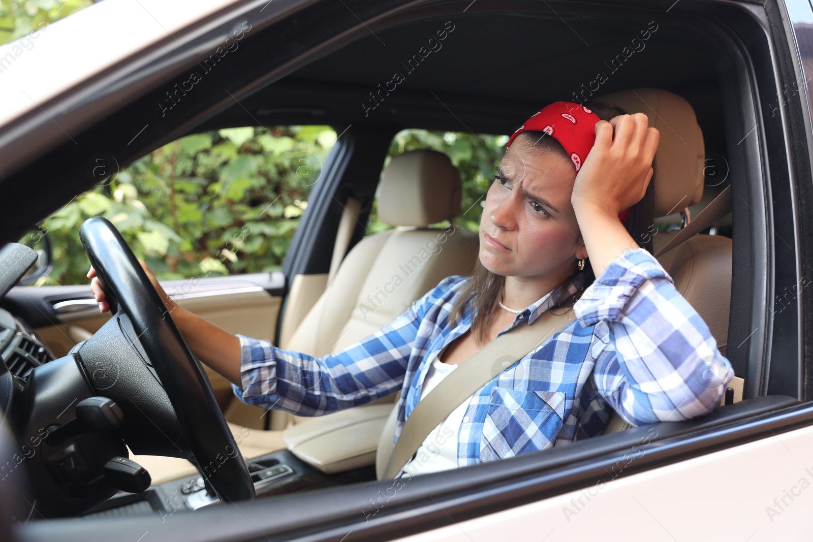 Photo of Emotional woman holding steering wheel while driving car, view from outside