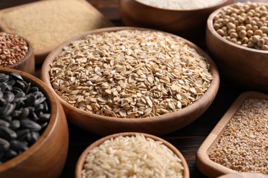 Photo of Different types of cereals, seeds and legumes on table, closeup