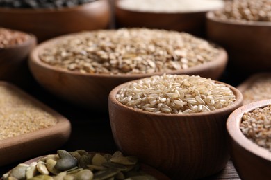 Photo of Different cereals and seeds on table, closeup