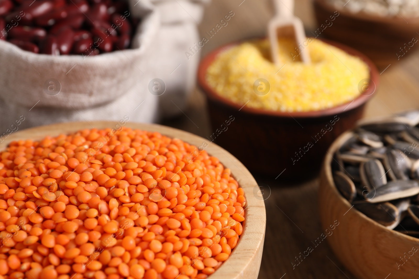 Photo of Different types of seeds and legumes on table, closeup