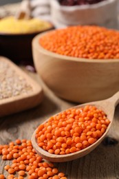 Photo of Natural lentils on wooden table, closeup view