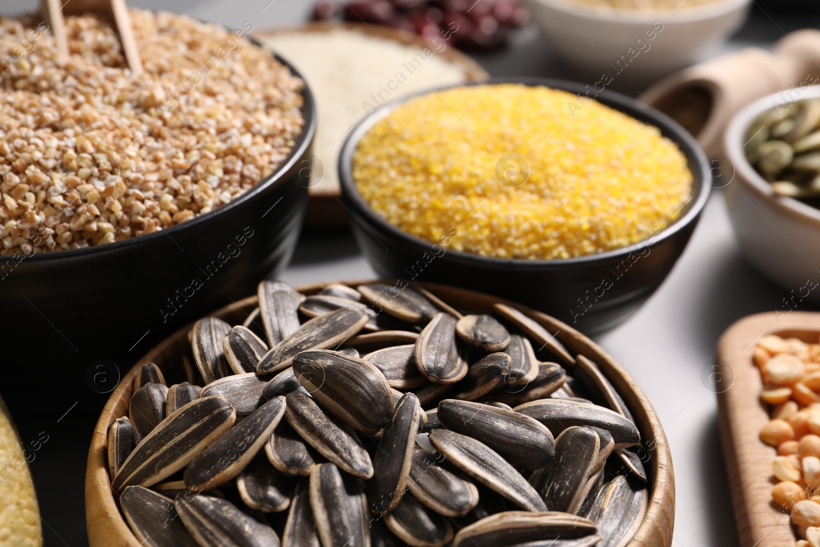 Photo of Different seeds and cereals on table, closeup