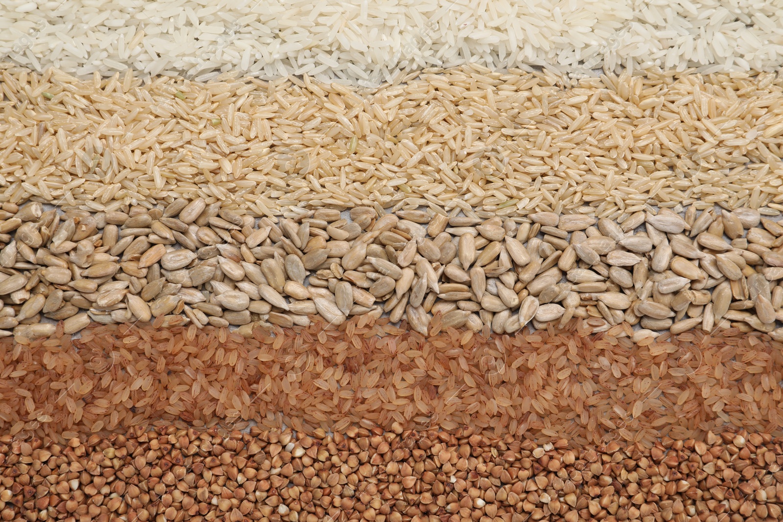 Photo of Different types of cereals and seeds on table, flat lay