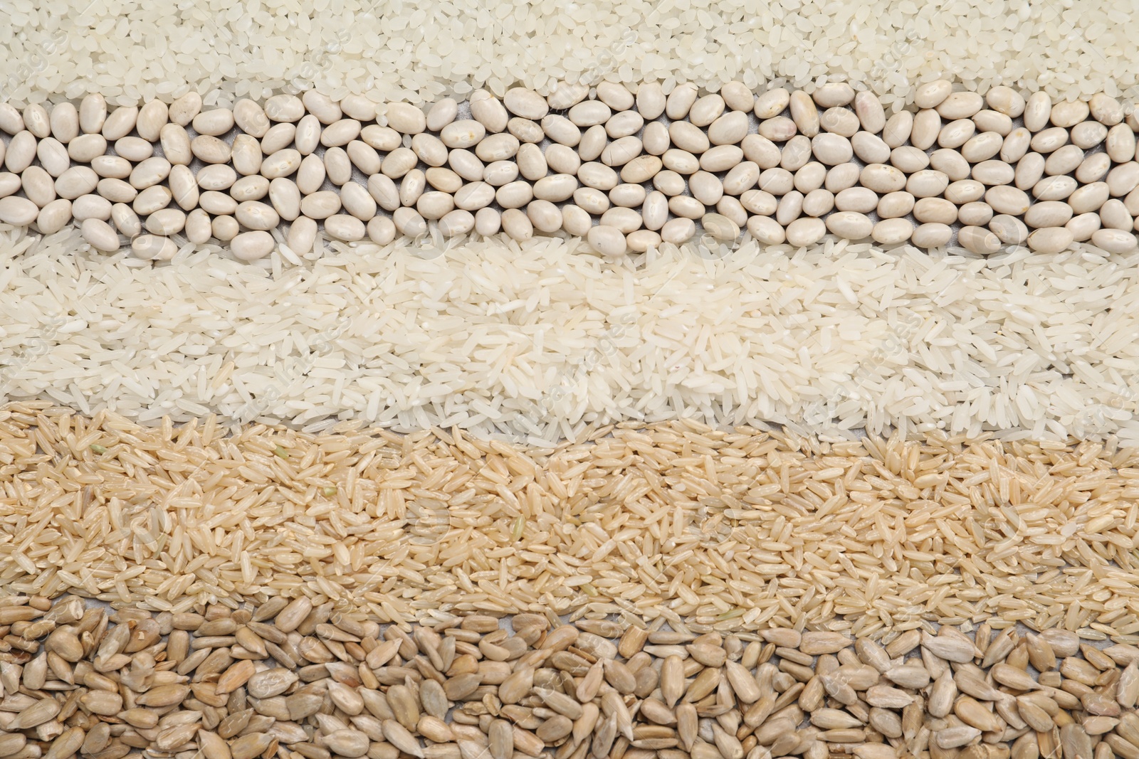 Photo of Different types of cereals, legumes and seeds on table, flat lay