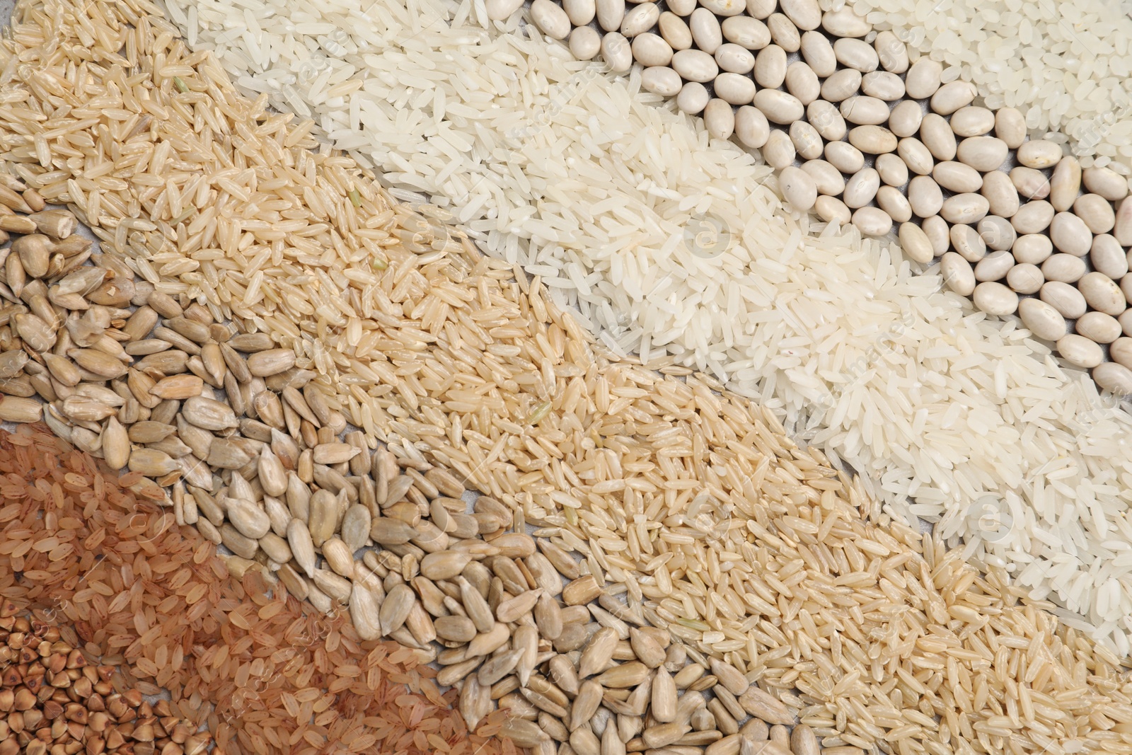 Photo of Different types of cereals, legumes and seeds on table, flat lay