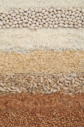 Photo of Different types of cereals, legumes and seeds on table, flat lay