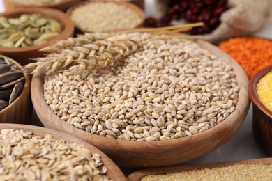 Photo of Different types of cereals, legumes and seeds on table, closeup