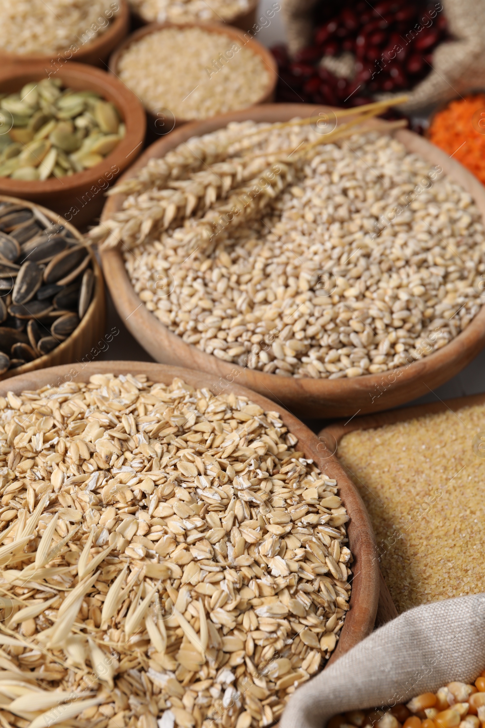 Photo of Different types of cereals, legumes and seeds on table, closeup