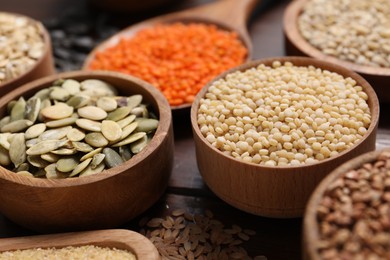 Photo of Different types of cereals, seeds and legumes on table, closeup