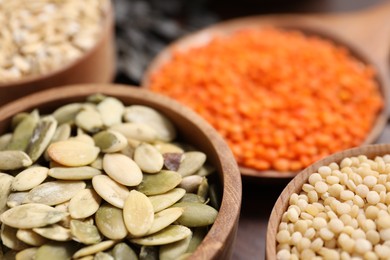 Photo of Different types of cereals, seeds and legumes on table, closeup