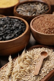 Photo of Different types of cereals and seeds on table, closeup