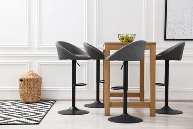 Photo of Bar stools near table in stylish room