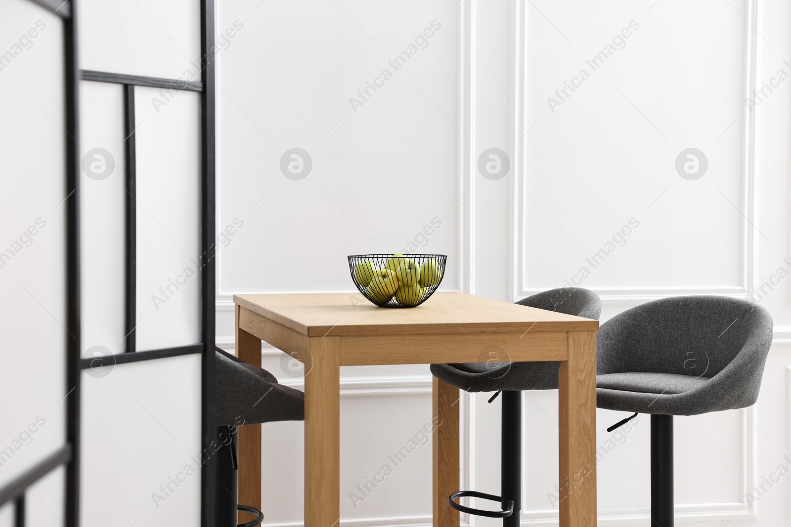 Photo of Bar stools, table and folding screen indoors