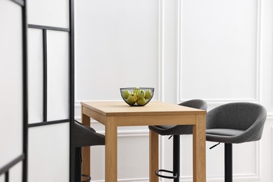 Photo of Bar stools, table and folding screen indoors