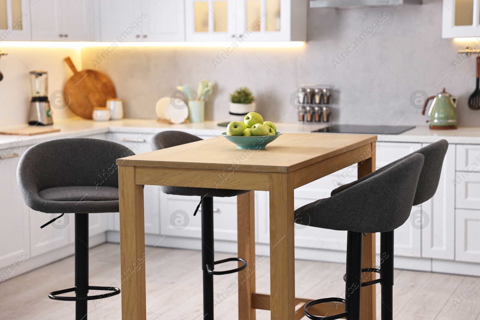 Photo of Bar stools near table in stylish kitchen