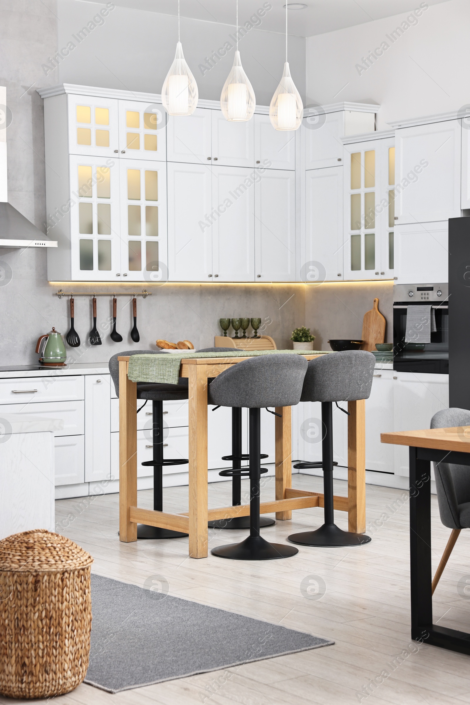 Photo of Bar stools near table in stylish kitchen