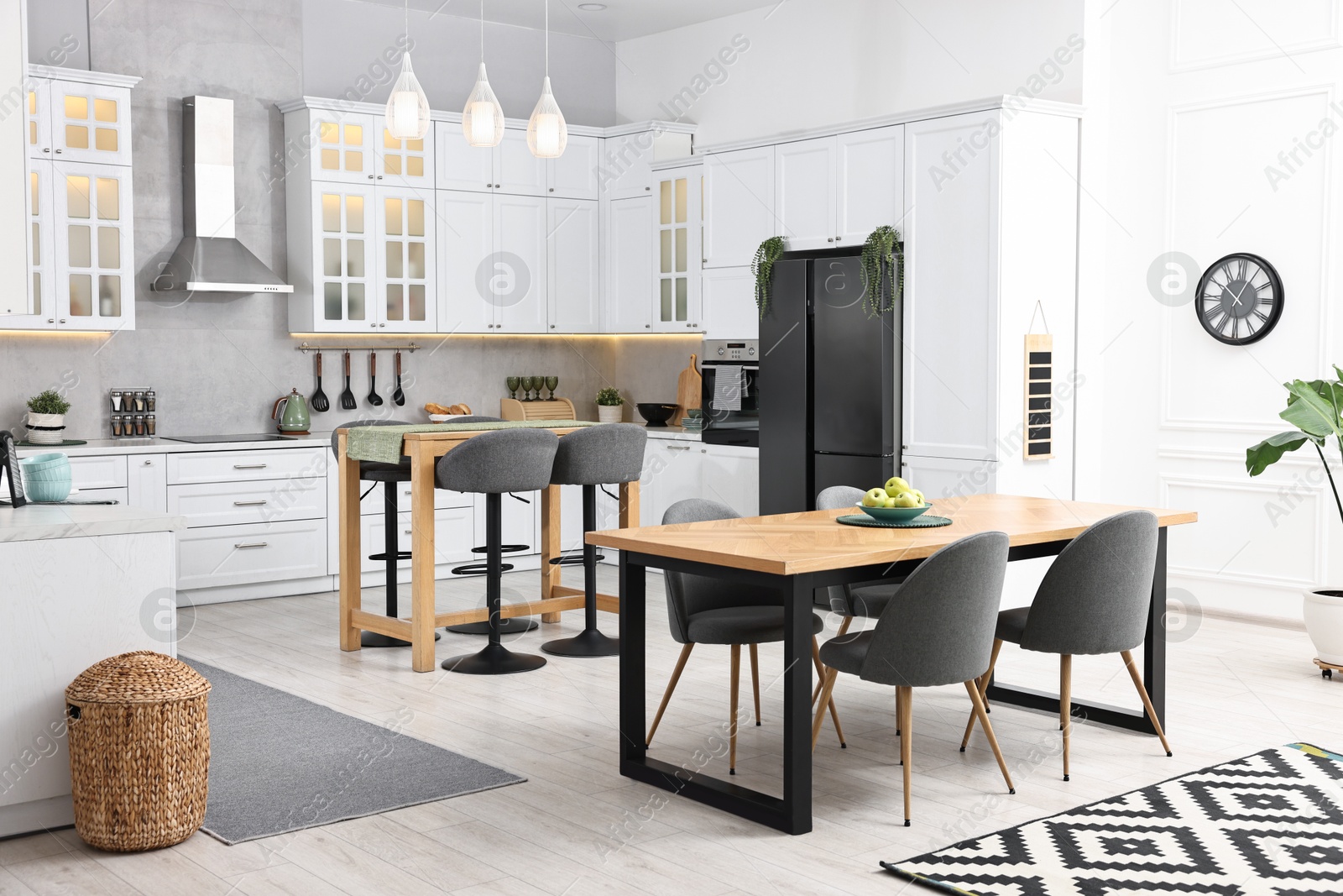 Photo of Bar stools, tables and other furniture in stylish kitchen