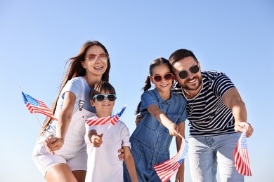 Photo of Happy family with flags of USA outdoors