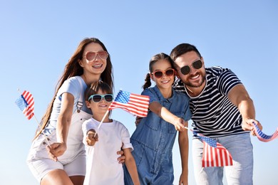 Happy family with flags of USA outdoors