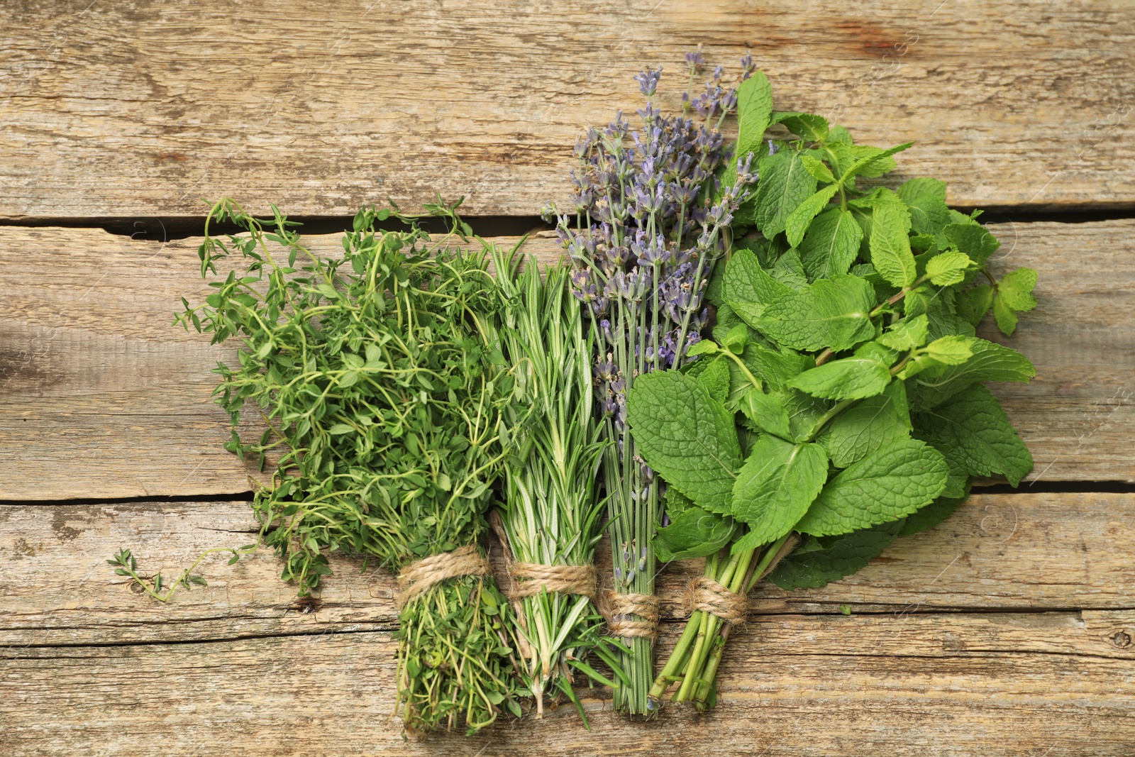 Photo of Different aromatic herbs on wooden table, top view