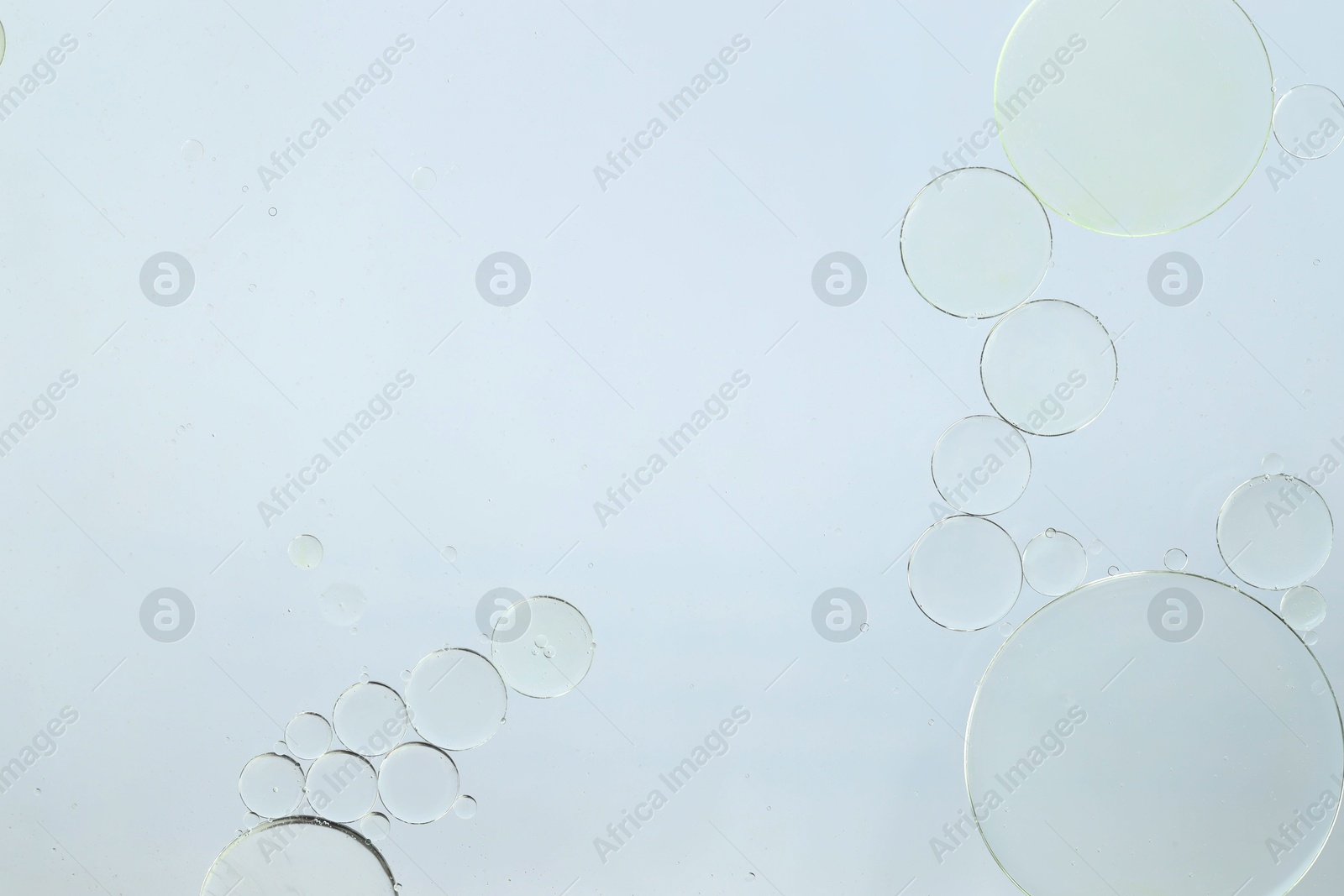 Photo of Sample of cosmetic oil on white background, macro view