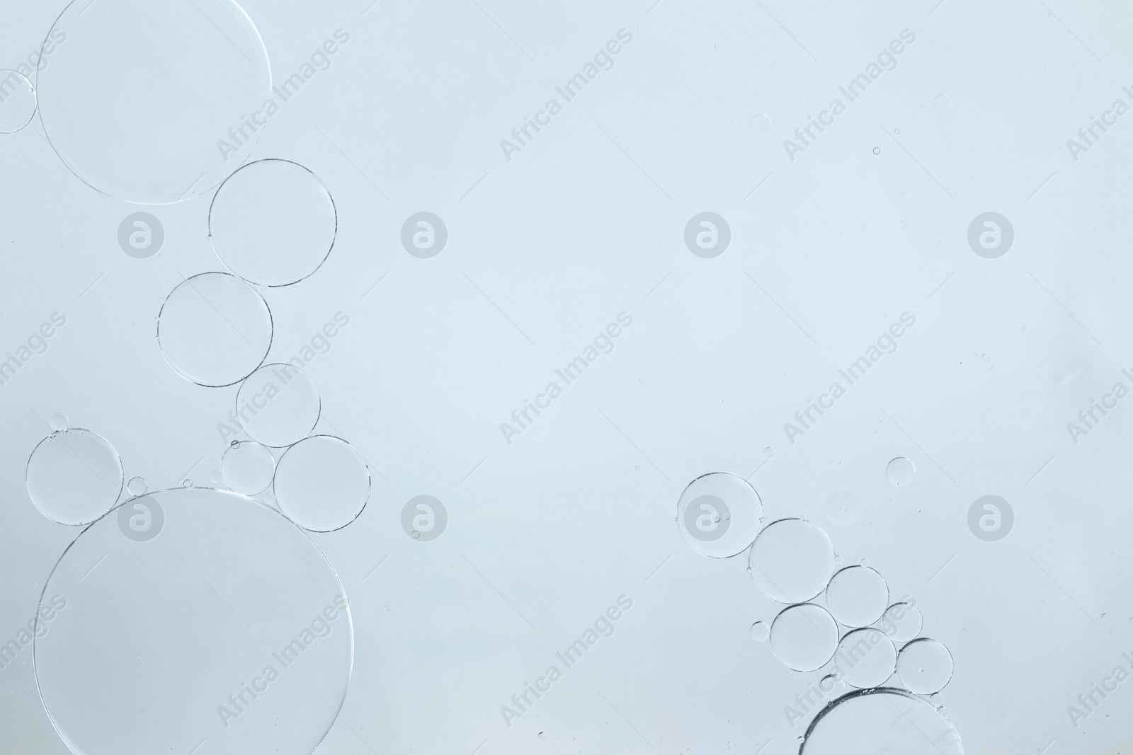 Photo of Sample of cosmetic oil on white background, macro view